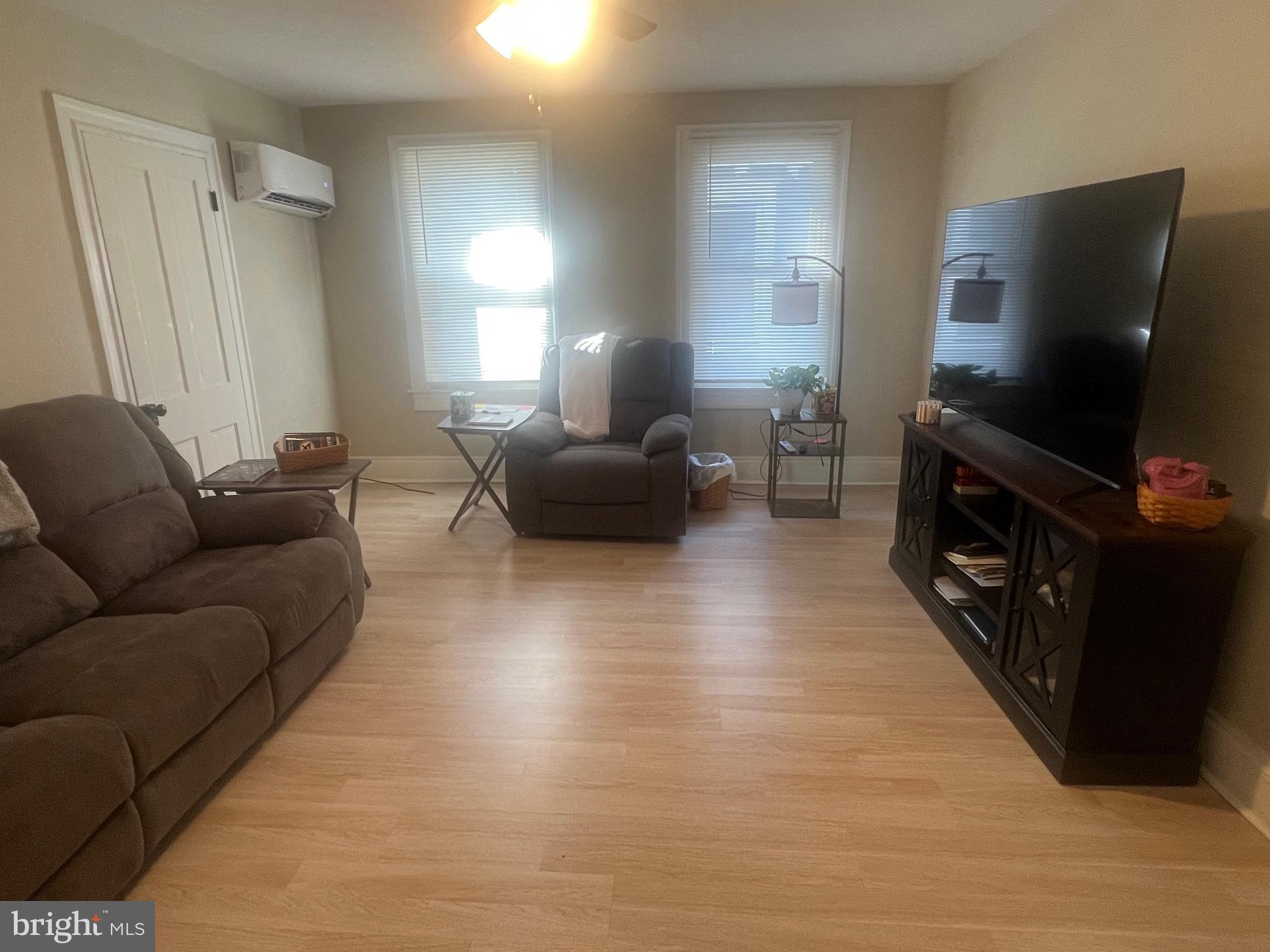 810 North Division Street Salisbury, MD 21801 - Photo 3 of 38 a living room with furniture and a flat screen tv