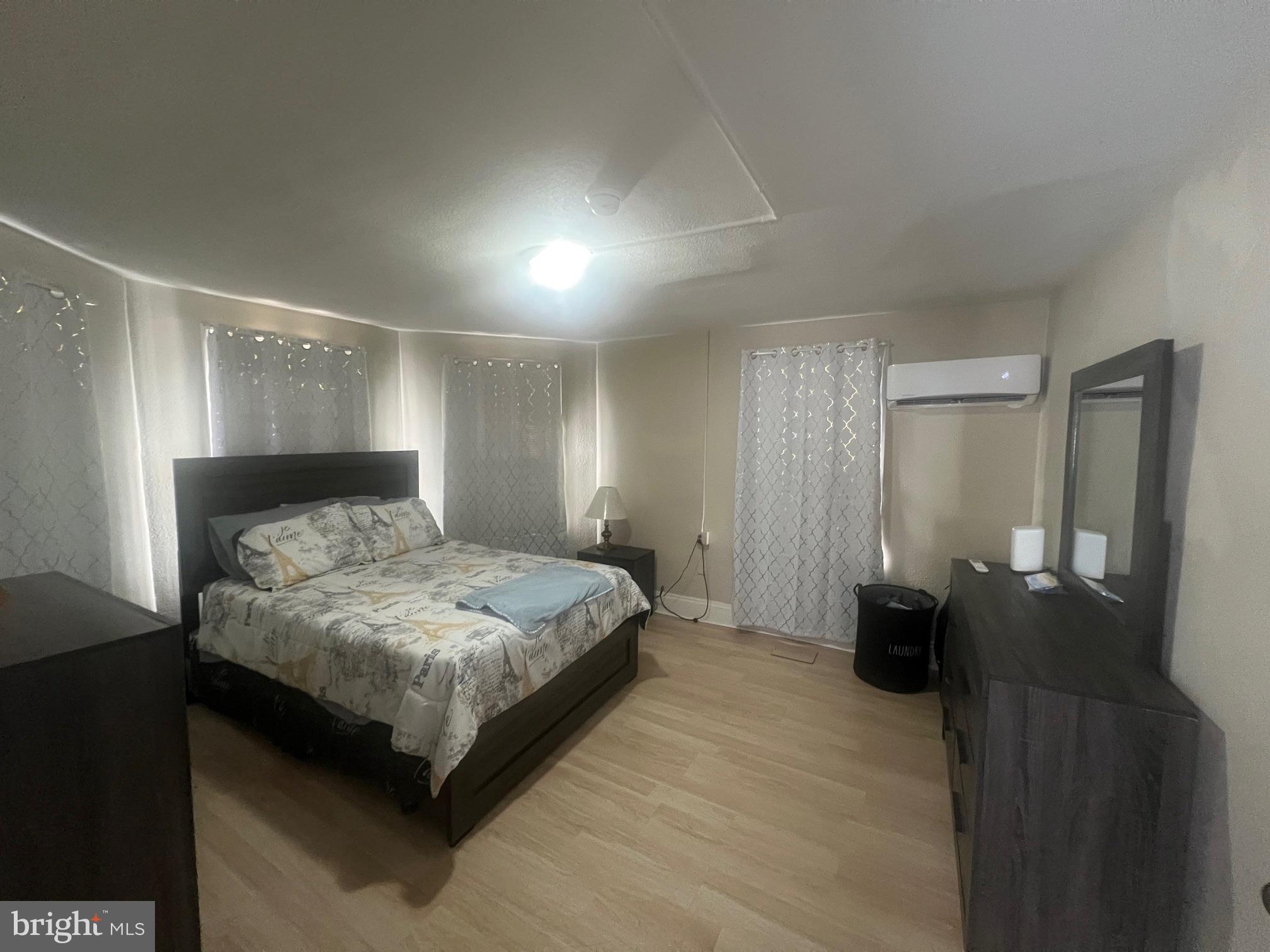 810 North Division Street Salisbury, MD 21801 - Photo 10 of 38 a bedroom with a bed and a lamp