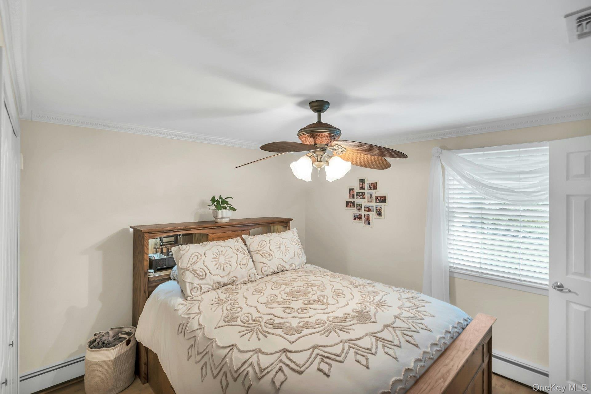 71 Ridge Haven Drive Ridge, NY 11961 - Photo 12 of 23 Bedroom With Crown Molding & Wood Floor