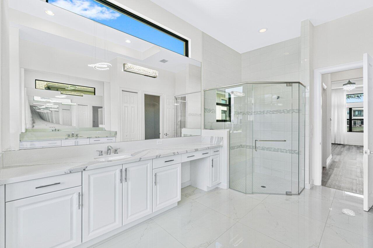17352 Rosella Road Boca Raton, FL 33496 - Photo 18 of 41 a spacious bathroom with a granite countertop sink and a mirror