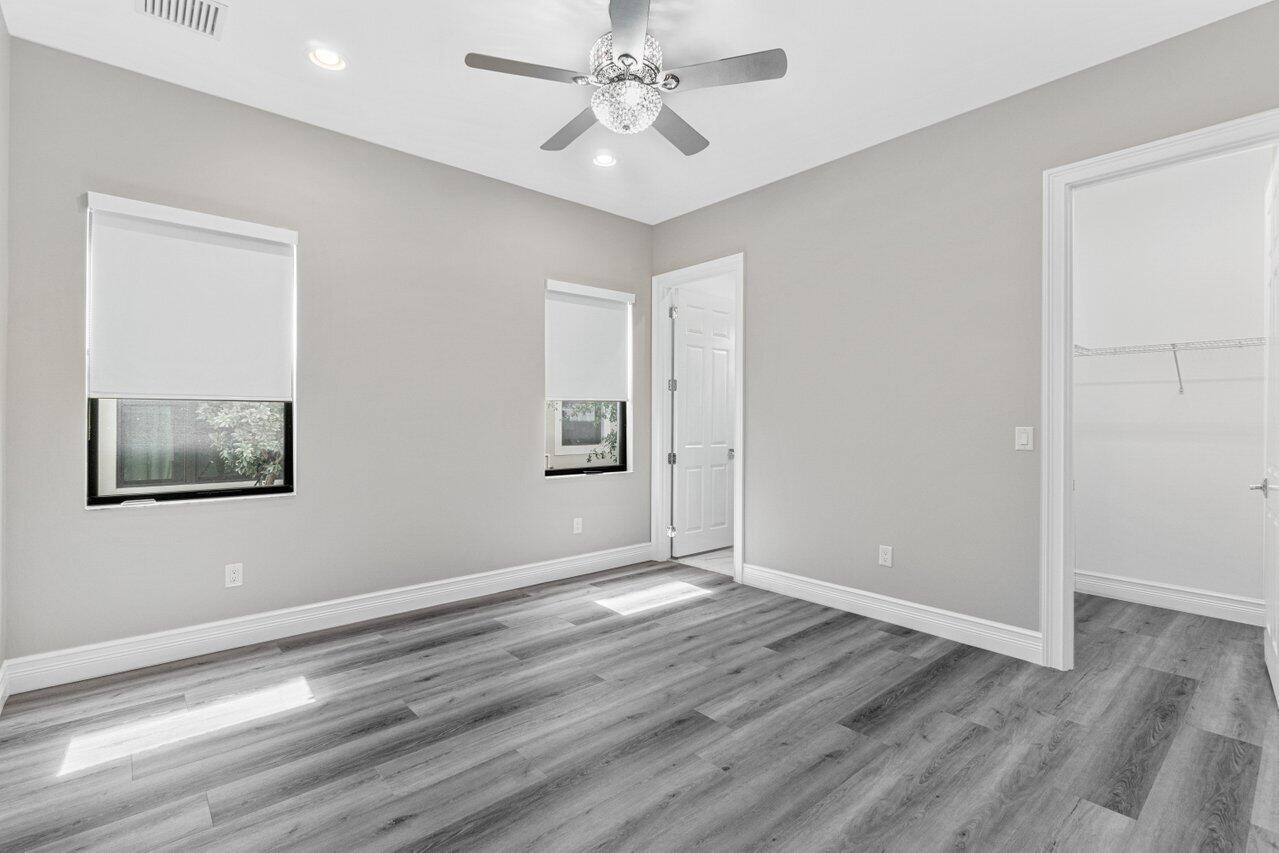 17352 Rosella Road Boca Raton, FL 33496 - Photo 20 of 41 wooden floor in an empty room with a window