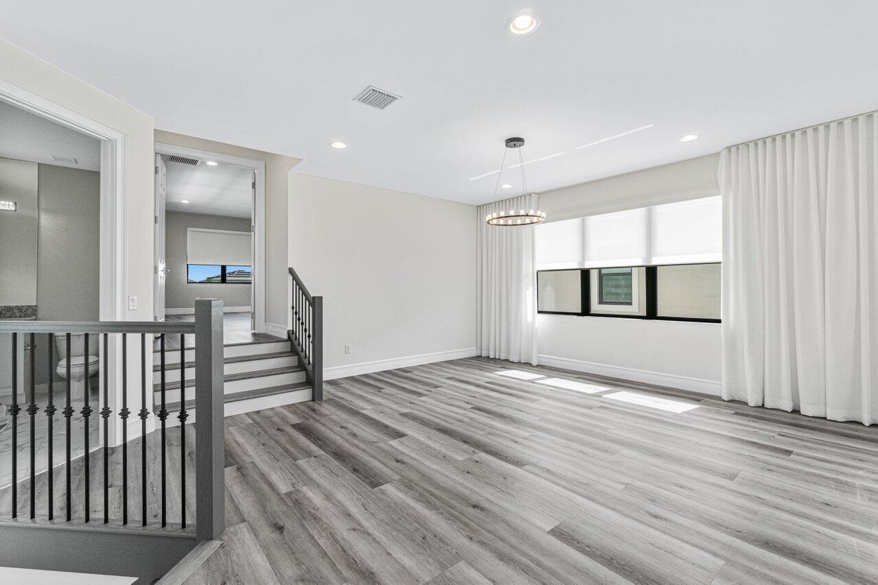 17352 Rosella Road Boca Raton, FL 33496 - Photo 23 of 41 a view of empty room with wooden floor and fan