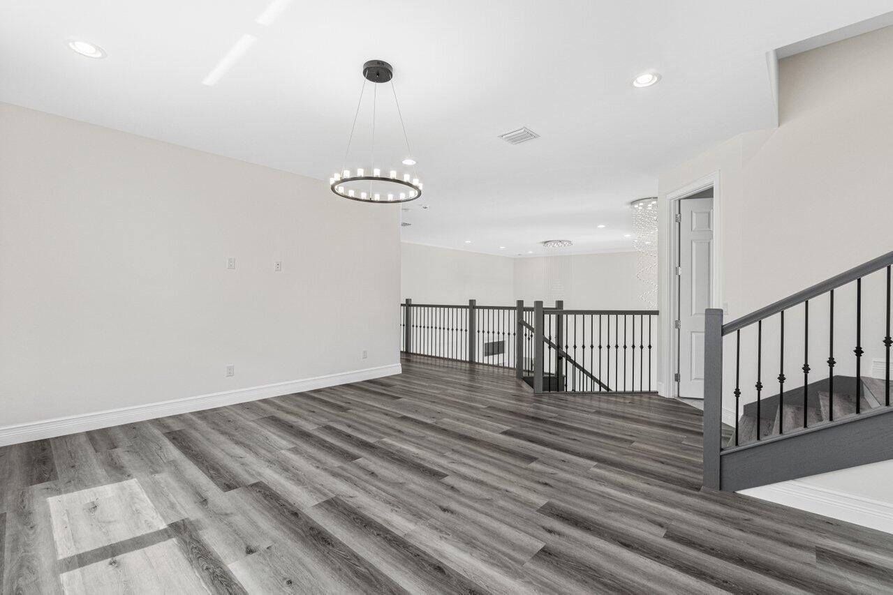 17352 Rosella Road Boca Raton, FL 33496 - Photo 24 of 41 an empty room with wooden floor and windows