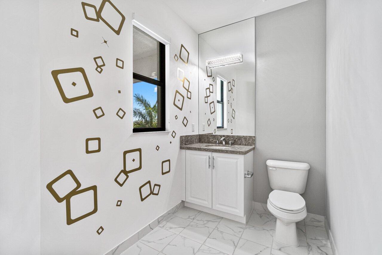17352 Rosella Road Boca Raton, FL 33496 - Photo 25 of 41 a bathroom with a toilet sink and mirror