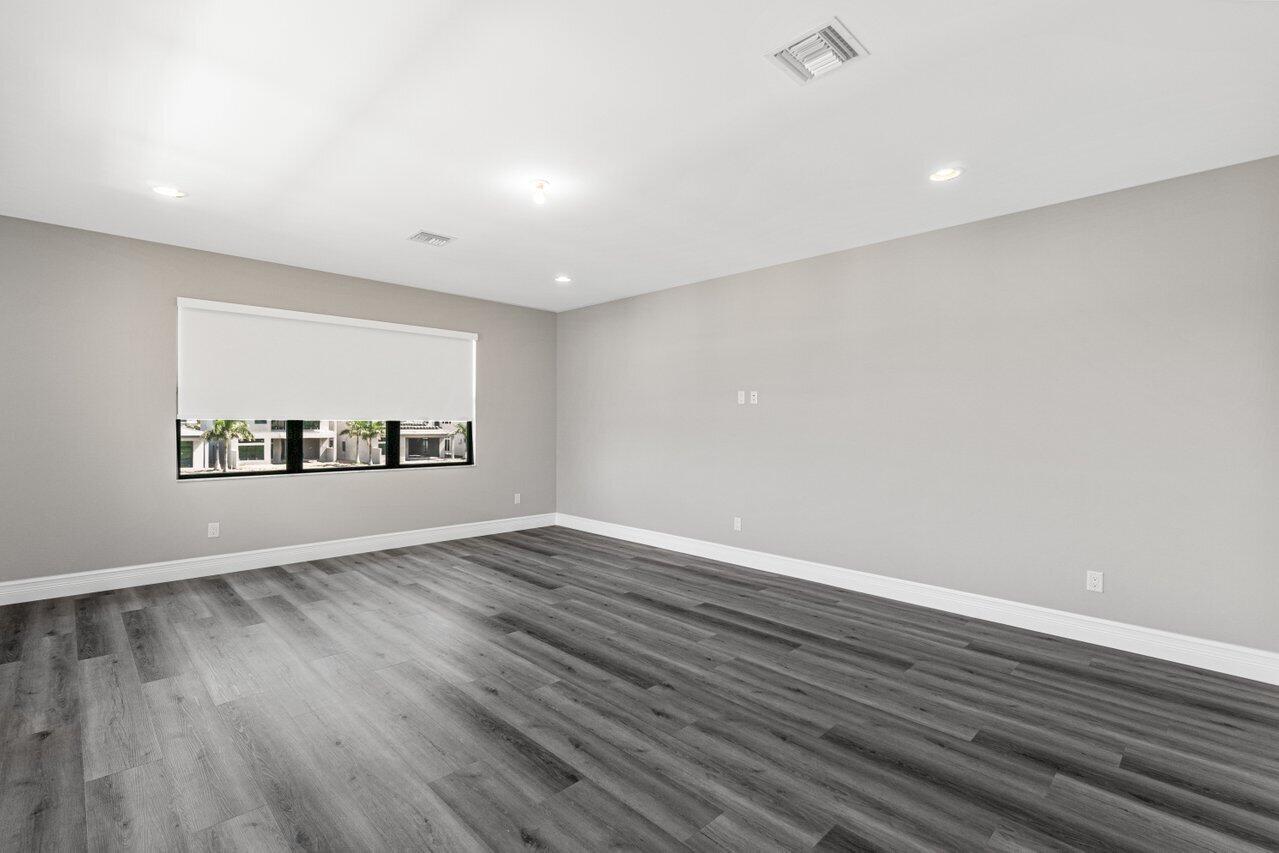 17352 Rosella Road Boca Raton, FL 33496 - Photo 26 of 41 a view of an empty room with wooden floor and a window