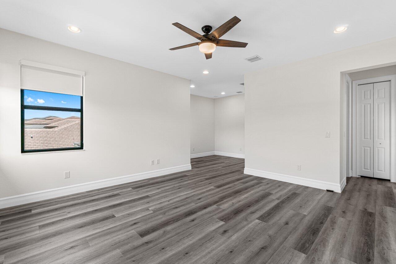 17352 Rosella Road Boca Raton, FL 33496 - Photo 29 of 41 an empty room with wooden floor and windows