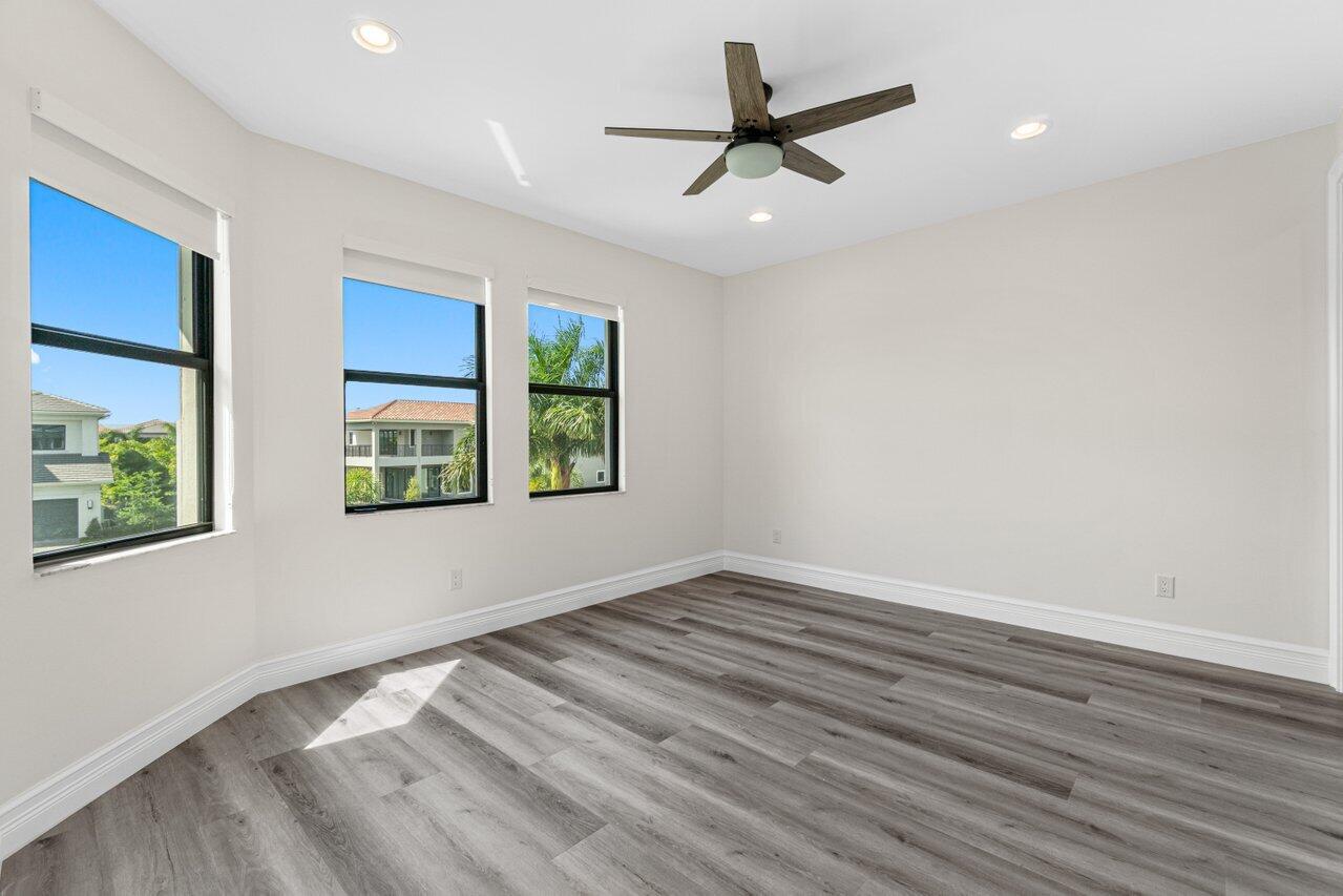 17352 Rosella Road Boca Raton, FL 33496 - Photo 32 of 41 an empty room with wooden floor and windows