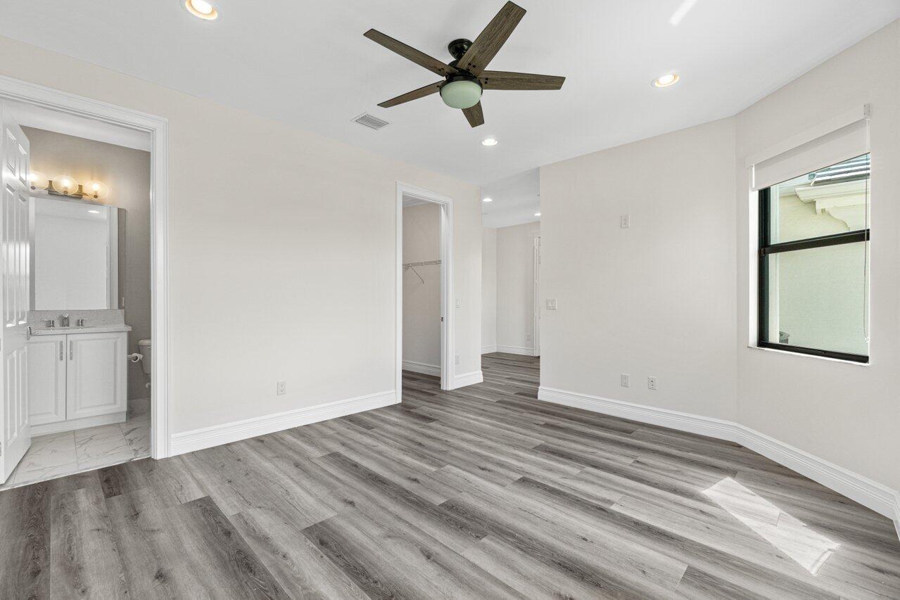 17352 Rosella Road Boca Raton, FL 33496 - Photo 33 of 41 an empty room with wooden floor and a ceiling fan