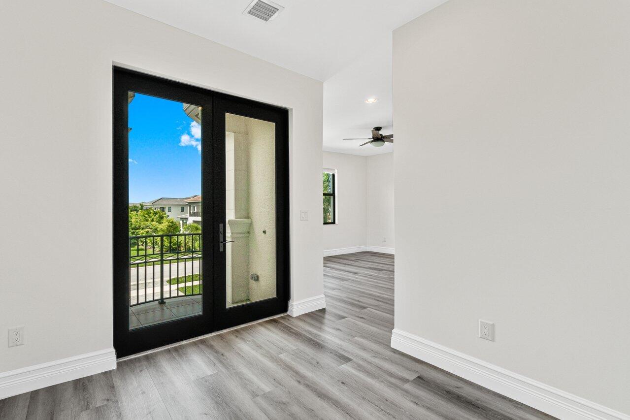 17352 Rosella Road Boca Raton, FL 33496 - Photo 34 of 41 a view of empty room with wooden floor and fan