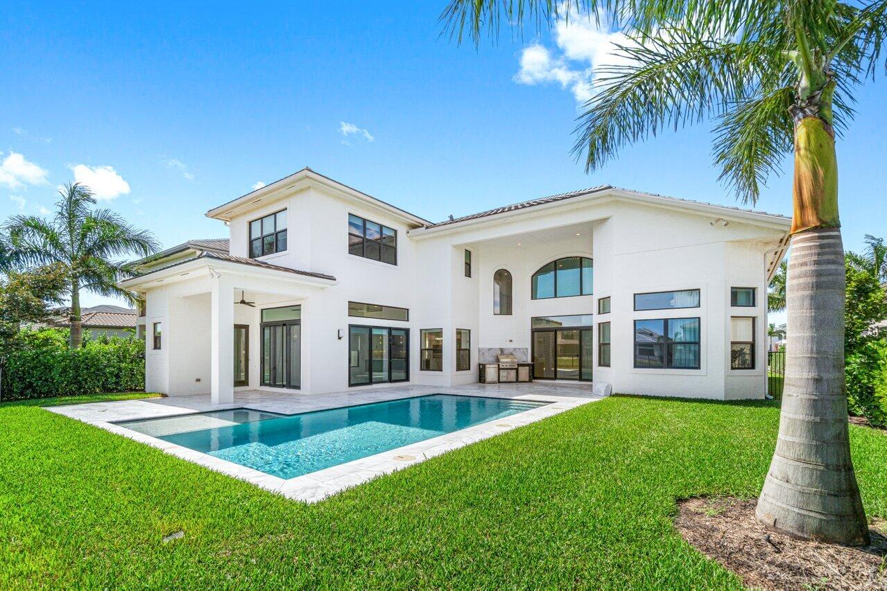 17352 Rosella Road Boca Raton, FL 33496 - Photo 37 of 41 a front view of a house with a yard table and chairs