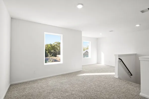 an empty room with windows and closet