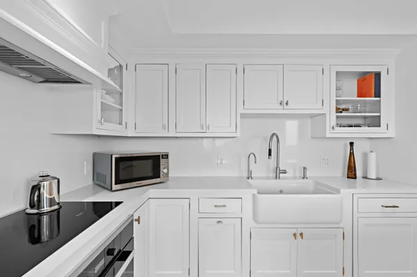 a kitchen with white cabinets and a sink