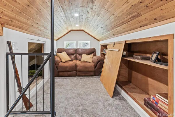 a living room with furniture and a ceiling fan