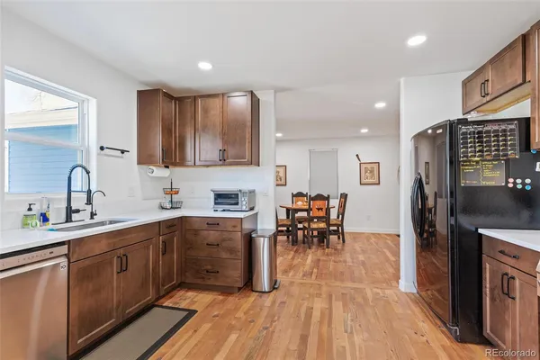 a kitchen with stainless steel appliances a sink counter space and cabinets