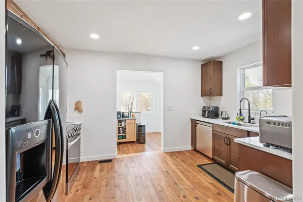 a kitchen with cabinets and a wooden floor