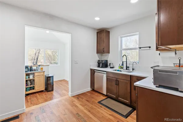 a kitchen with stainless steel appliances granite countertop a sink stove and cabinets
