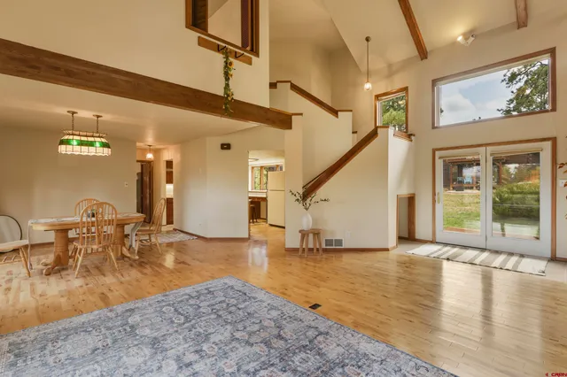 a view of a livingroom with furniture staircase and a kitchen