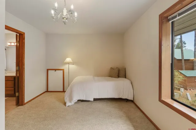 a bathroom with a double vanity sink toilet and a mirror