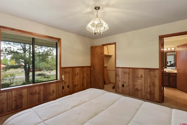 a view of a yard with wooden fence and a tree
