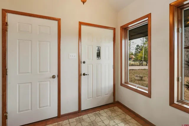 a view of a kitchen with furniture and stainless steel appliances