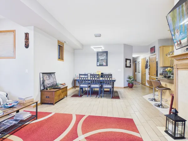 a living room with furniture a piano and a flat screen tv
