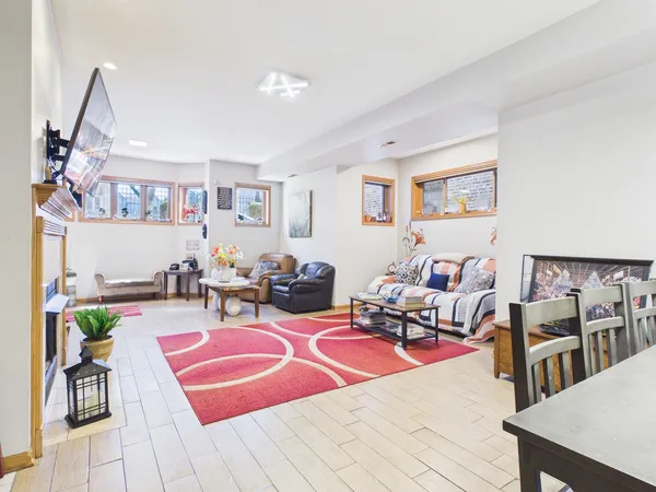 a living room with lots of furniture and a wooden floor