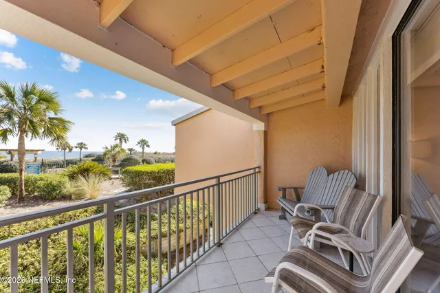 a kitchen with a dining table chairs stainless steel appliances and cabinets