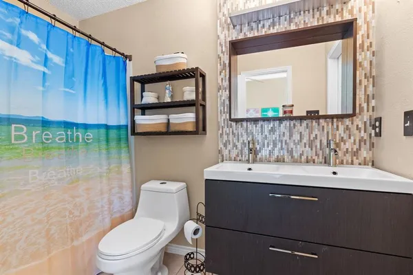 a bathroom with a toilet a sink and a mirror