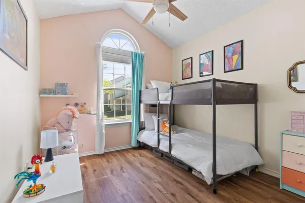 a living room with baby crib furniture a fireplace and a window