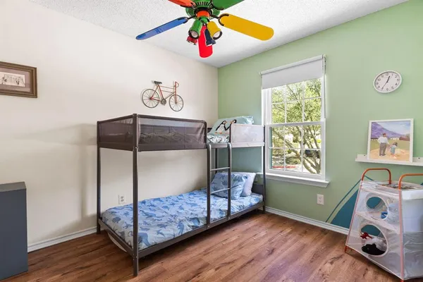 a bedroom with bunk bed and a window