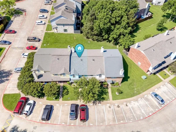 an aerial view of a house with a garden and trees