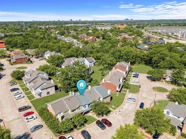 an aerial view of residential houses with outdoor space