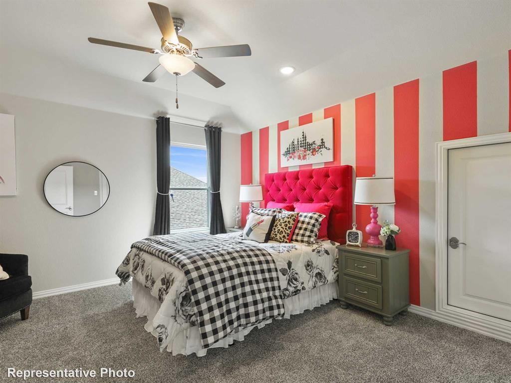 1143 Rothland Lane Red Oak, TX 75154 - Photo 12 of 18 Carpeted room featuring a ceiling fan with light fixture, a window with dark curtains, and a white paneled door with decorative trim