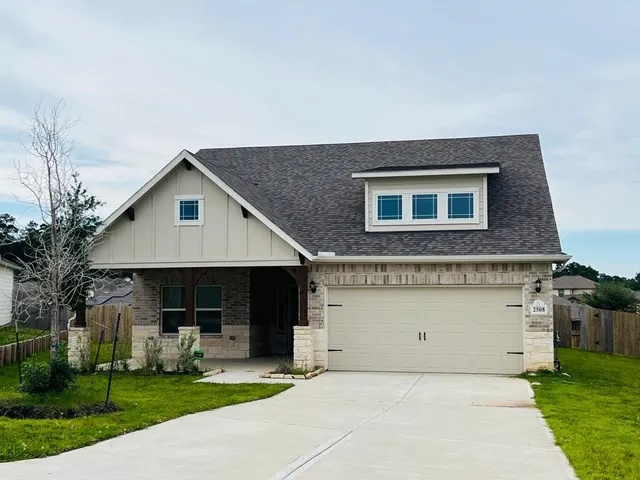 a front view of house with yard and green space