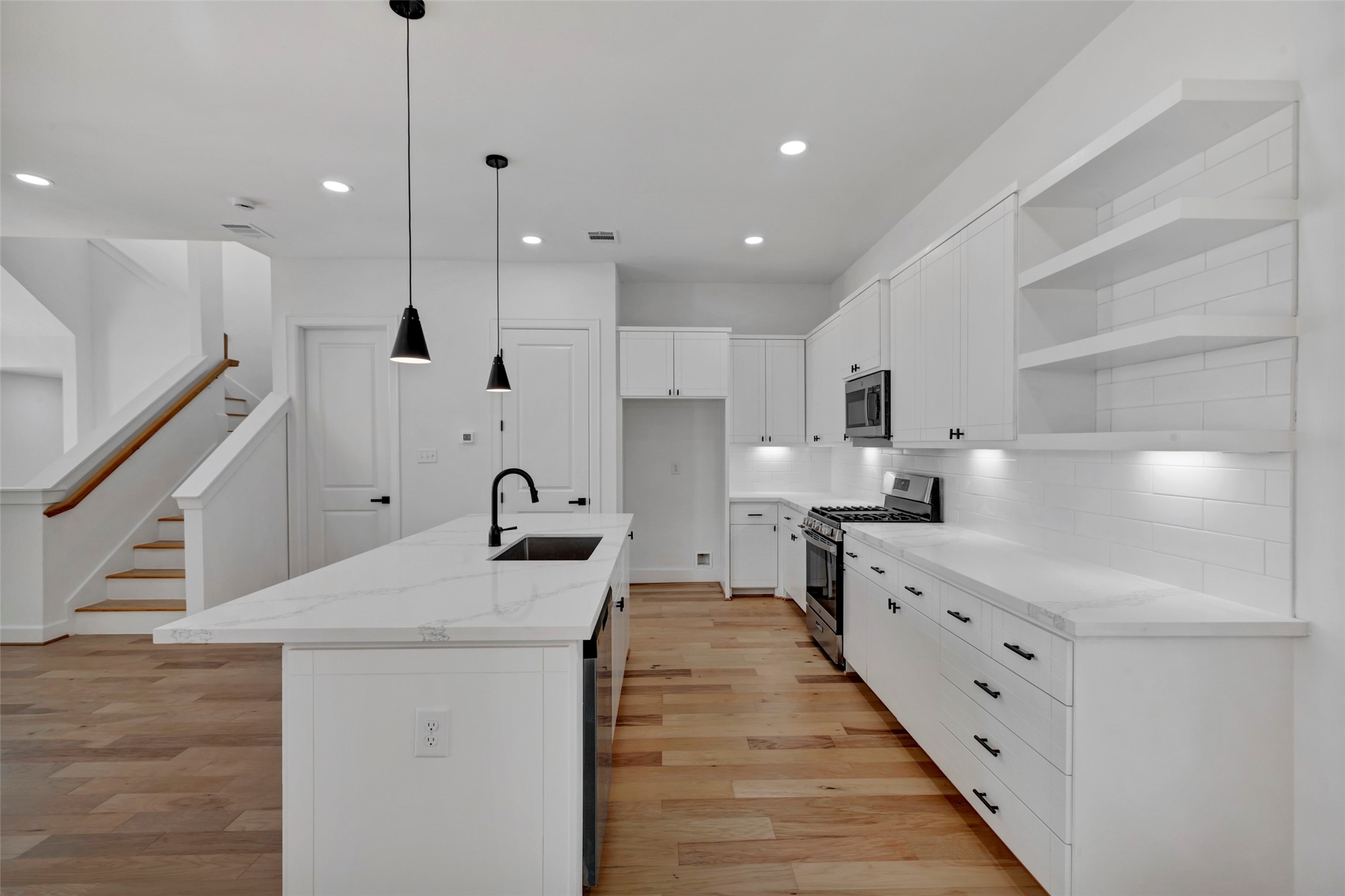 9426 Campbell Road, Unit B Houston, TX 77080 - Photo 16 of 28 a kitchen with white cabinets appliances and a window