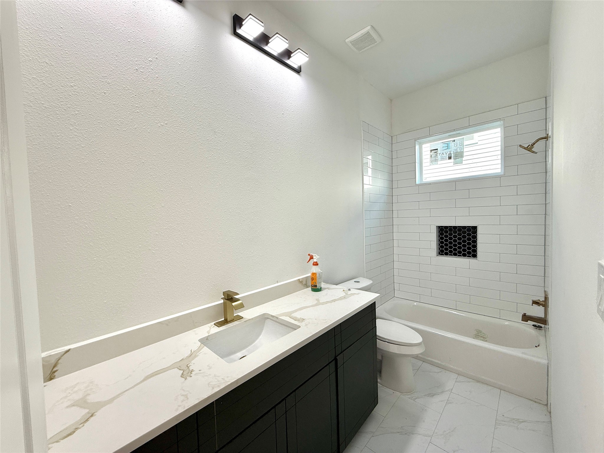 9426 Campbell Road, Unit B Houston, TX 77080 - Photo 3 of 28 a bathroom with a bathtub sink vanity and mirror