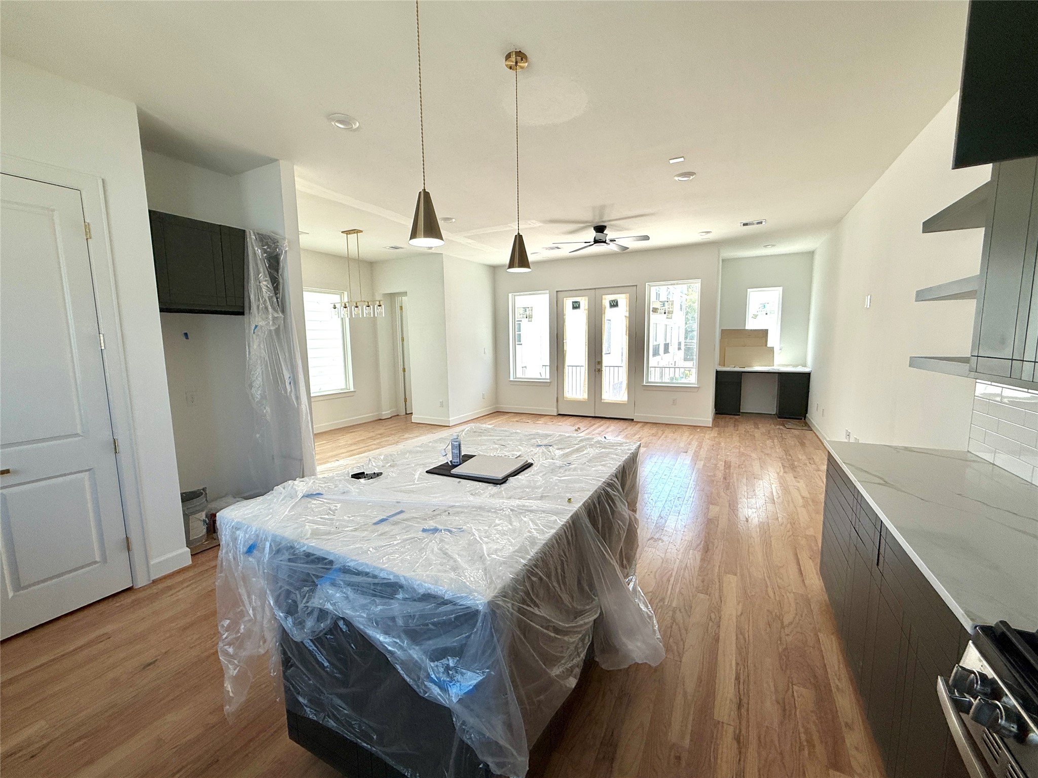 9426 Campbell Road, Unit B Houston, TX 77080 - Photo 5 of 28 a large kitchen with kitchen island a stove a sink dishwasher and a refrigerator with wooden floor