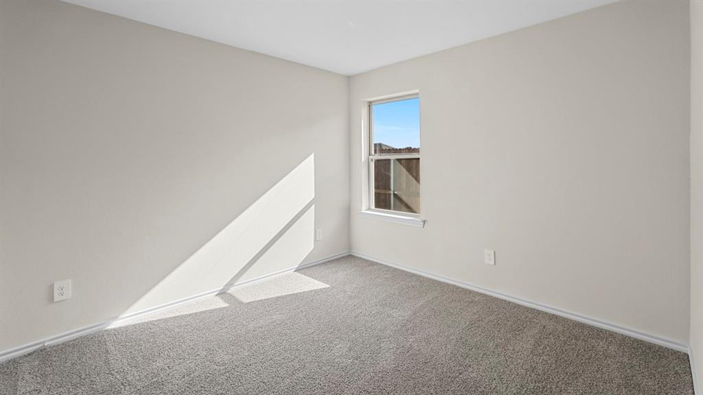 1953 Freeman Street Tyler, TX 75704 - Photo 27 of 32 Bright room featuring a single window, light-toned walls, and grey carpeting