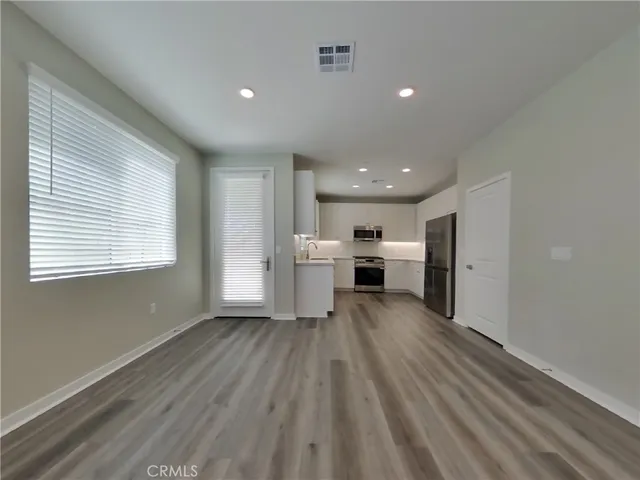 a kitchen with white cabinets stainless steel appliances and sink