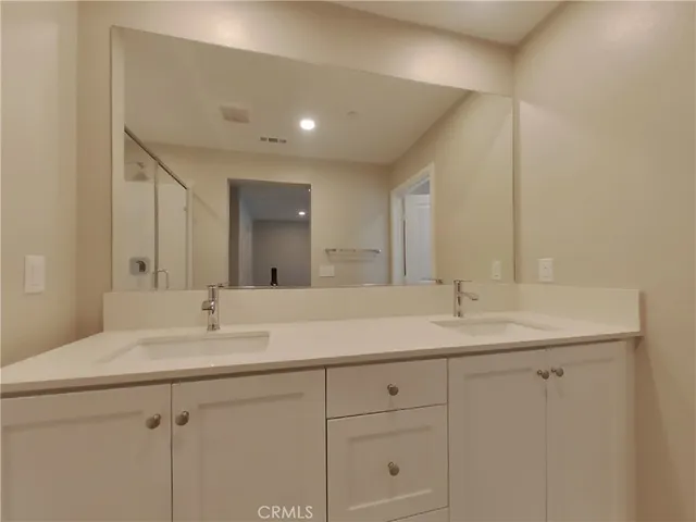 a bathroom with a shower and a sink