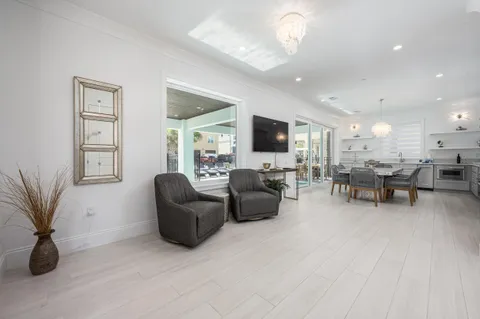 a large white kitchen with lots of counter space and breakfast area