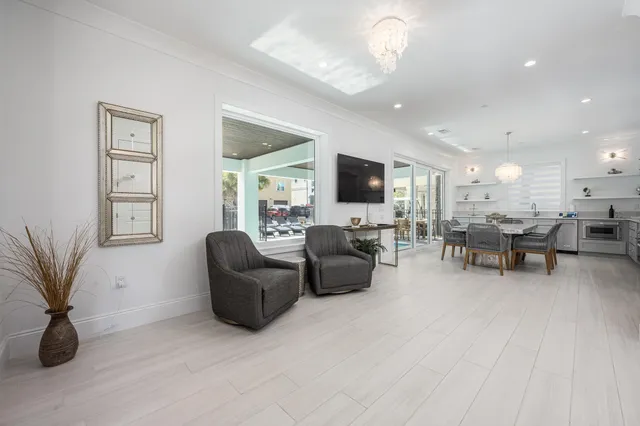 a large white kitchen with lots of counter space and breakfast area
