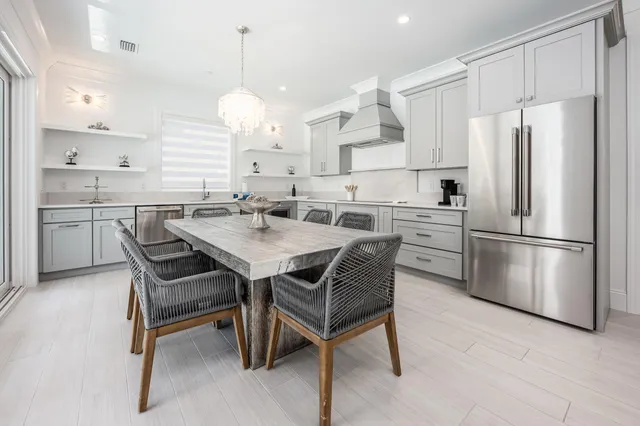 a kitchen with a stove a sink a dining table and chairs