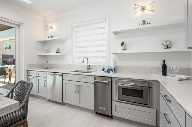 a large kitchen with kitchen island a stove a sink a dining table and chairs