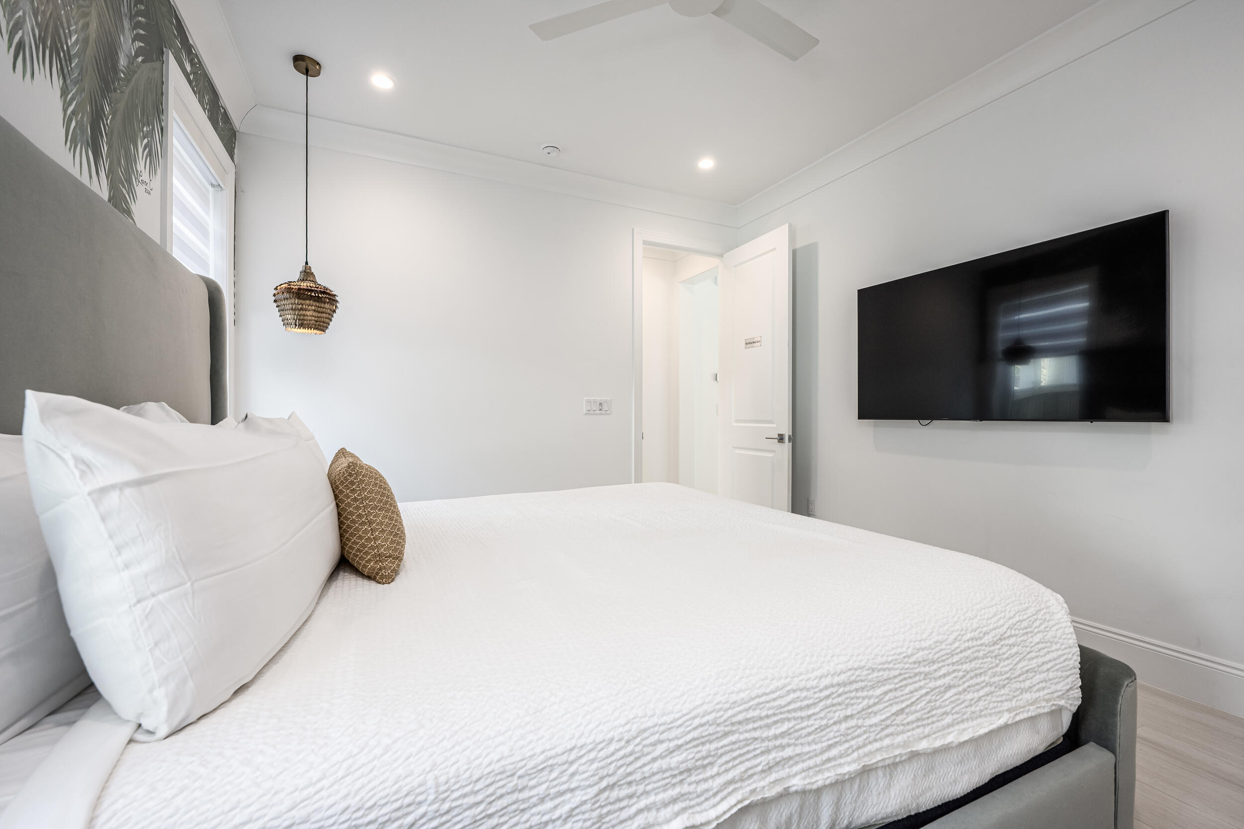 244 Open Gulf Street Miramar Beach, FL 32550 - Photo 25 of 151 a bedroom with a bed a flat screen tv and a large window