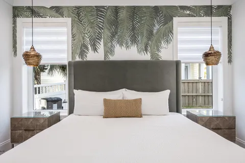 a bed sitting in a bedroom next to a window