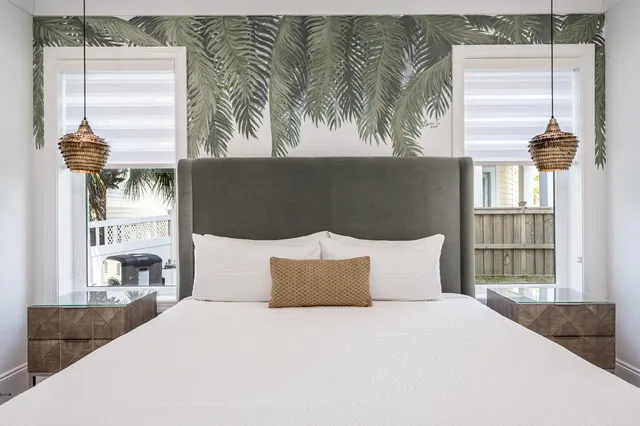 a bed sitting in a bedroom next to a window