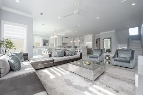 a bedroom with a bed a couch and a flat screen tv