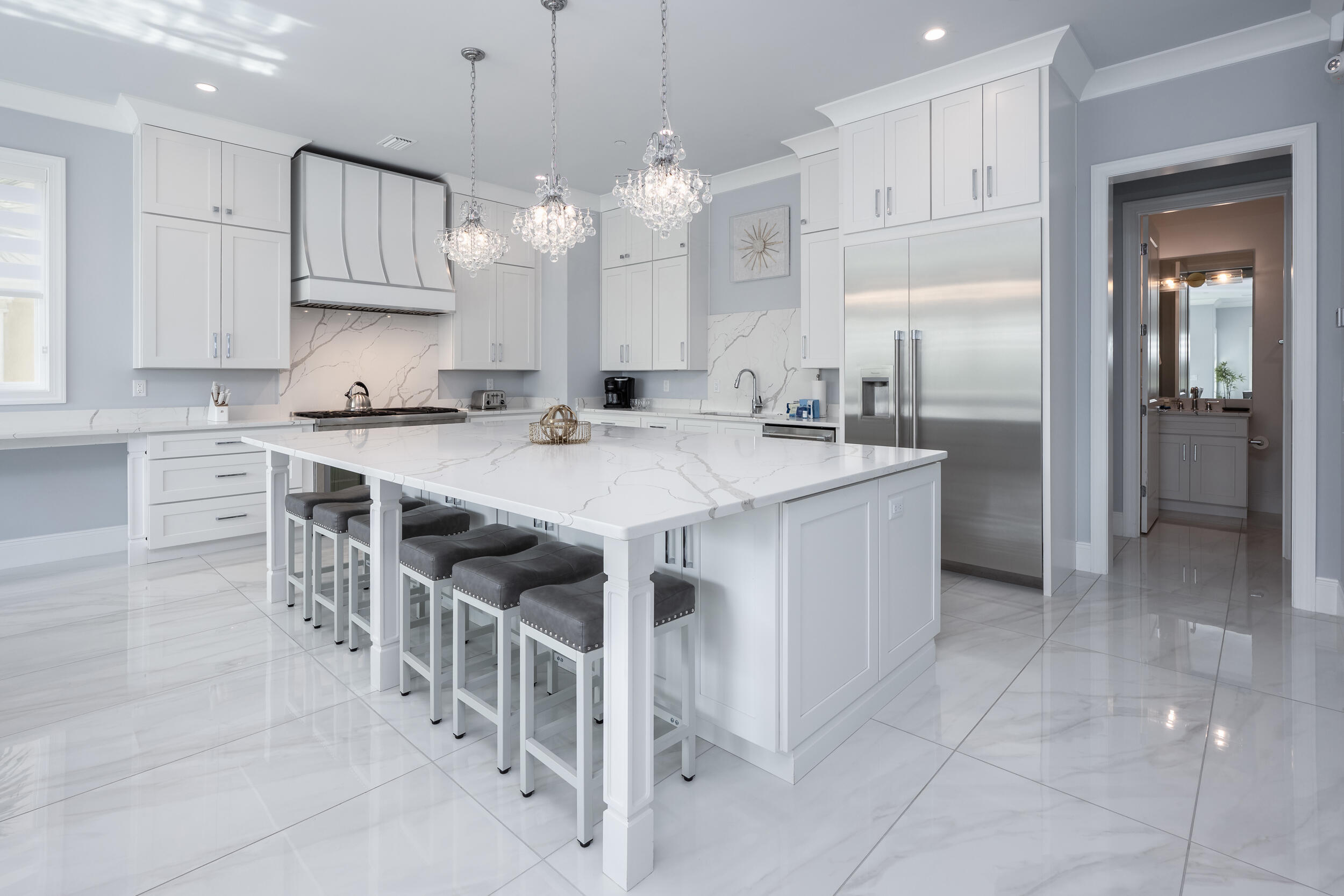 244 Open Gulf Street Miramar Beach, FL 32550 - Photo 42 of 151 a kitchen with stainless steel appliances granite countertop a sink a stove a refrigerator and island with wooden floor