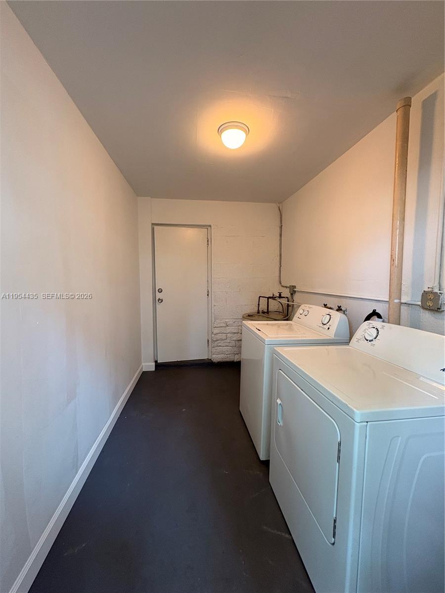 2390 Northwest 30th Street Miami, FL 33142 - Photo 14 of 14 a utility room with cabinets washer and dryer